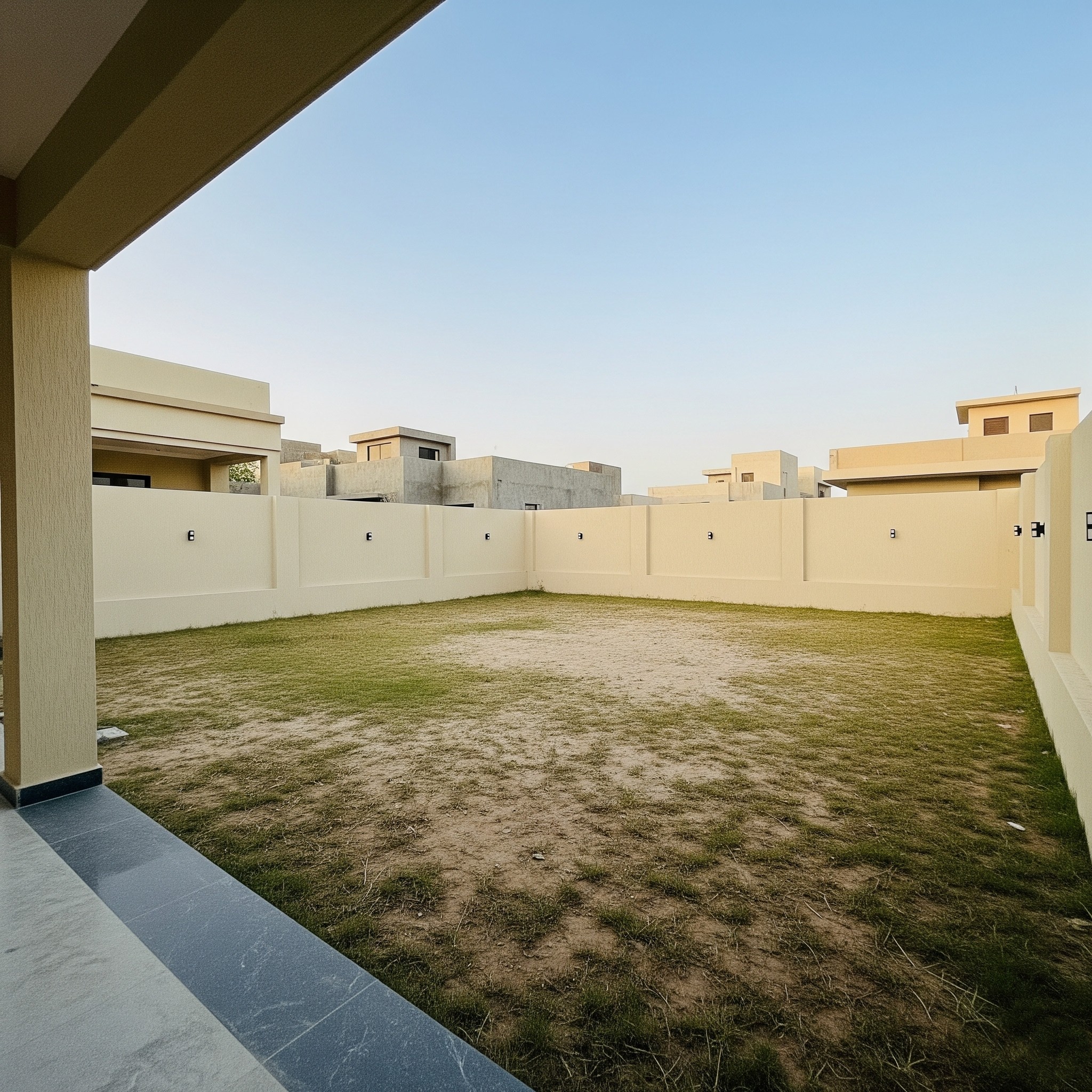 Before outdoor kitchen installation: A plain backyard space in Karachi, ready for a functional culinary area.