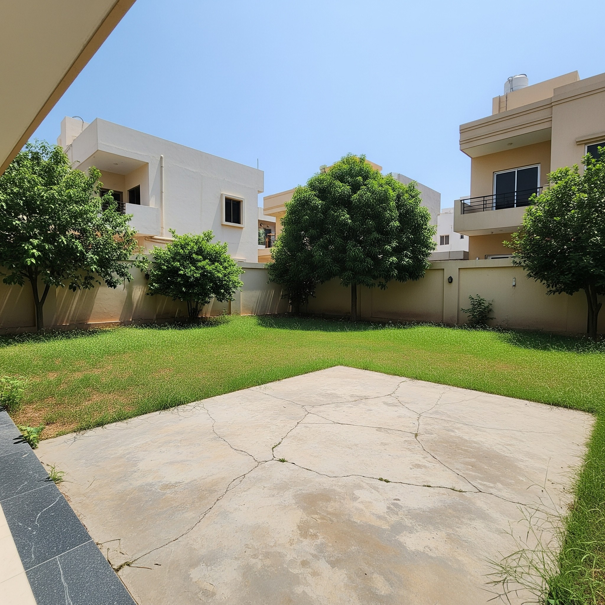 Before deck renovation: An unutilized, plain backyard space in Karachi, awaiting a modern deck transformation.