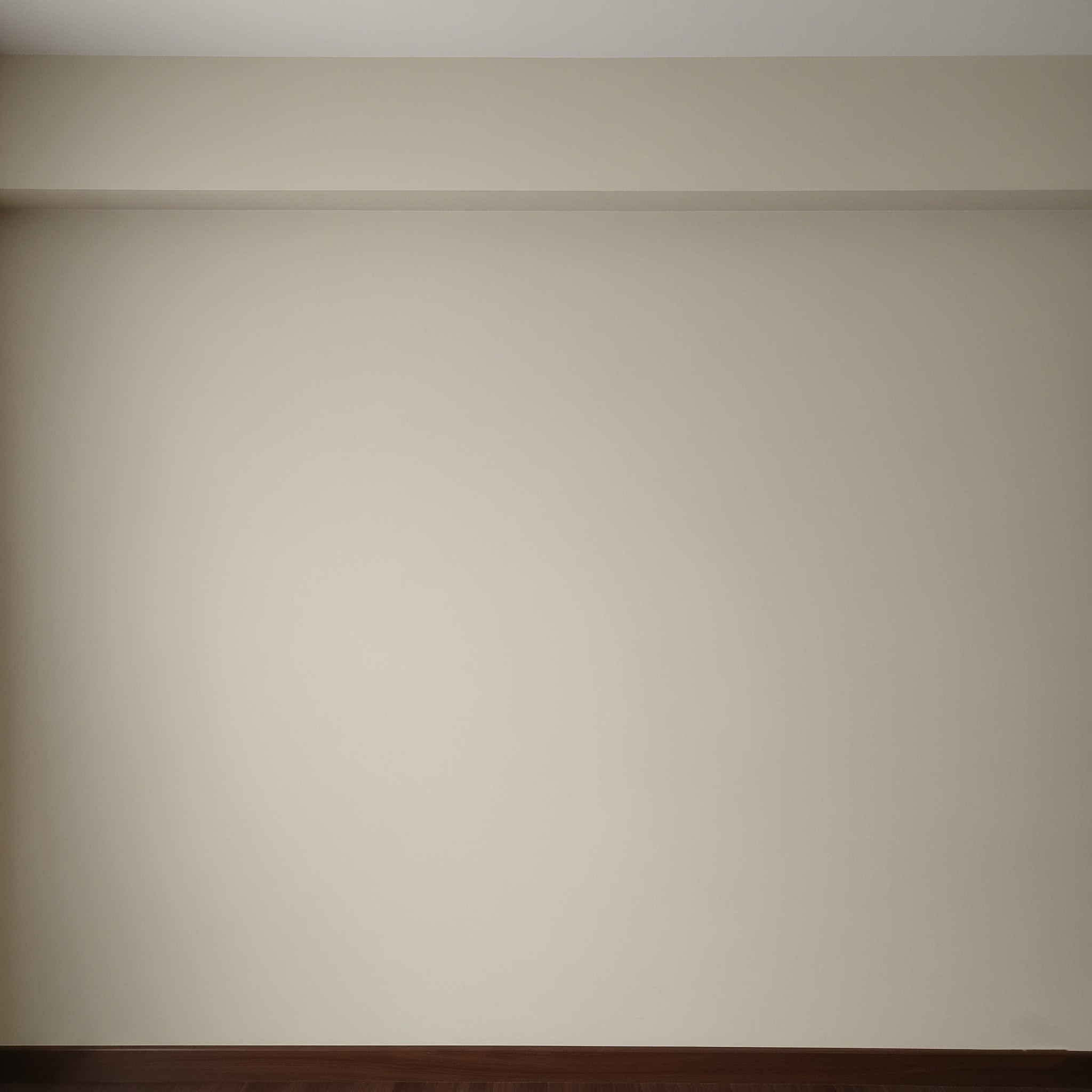 Before interior painting: A plain, uninspired wall in a living room in Karachi.