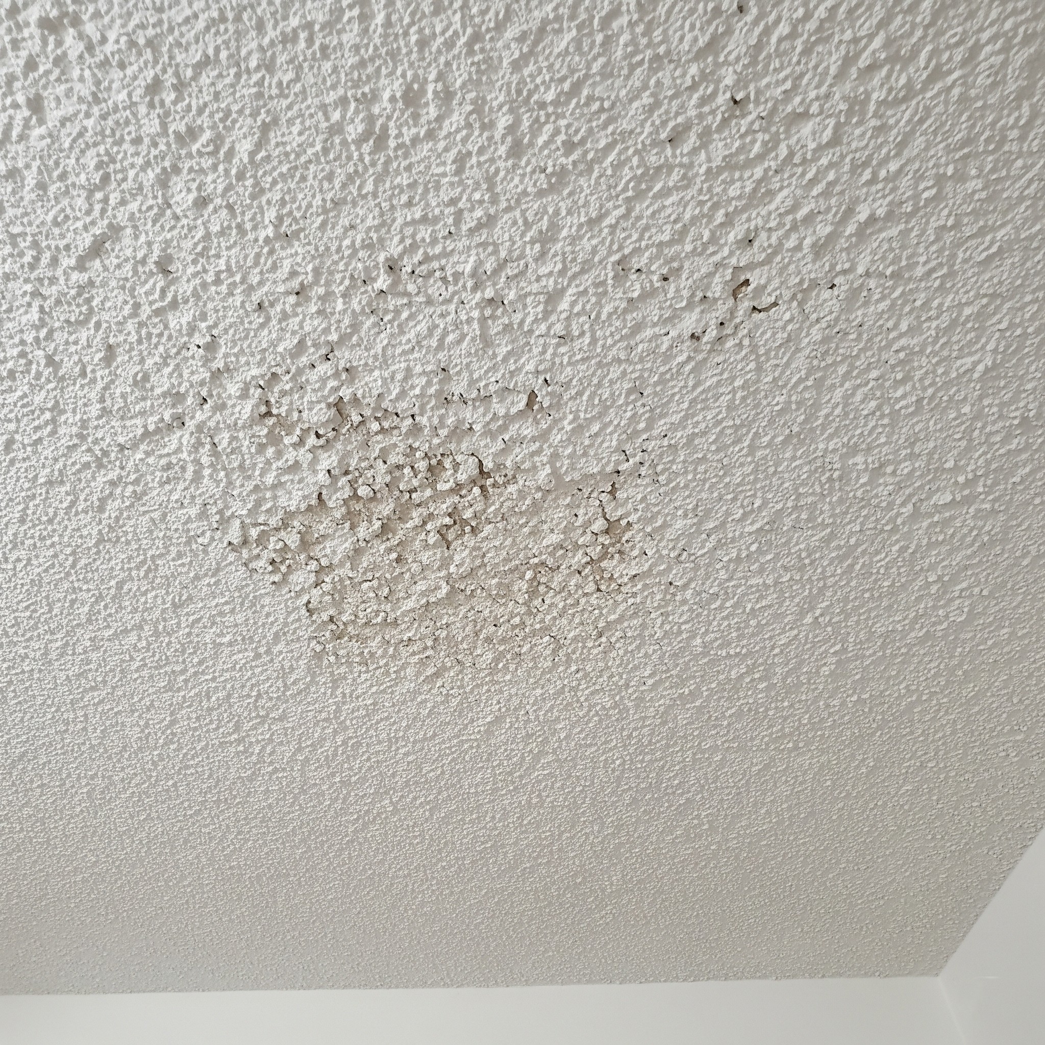 Before ceiling painting: An old, popcorn-textured ceiling in Karachi.