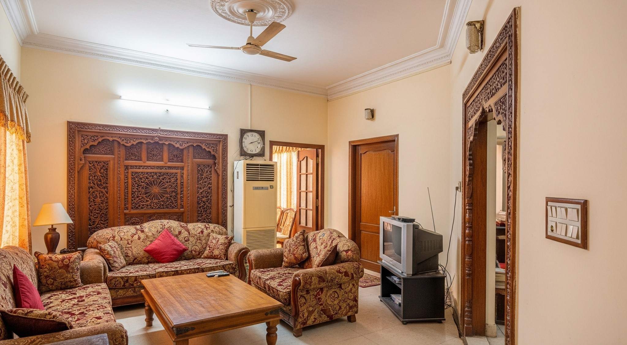 Before smart home upgrade: A traditional living room in a Karachi home with standard lighting.